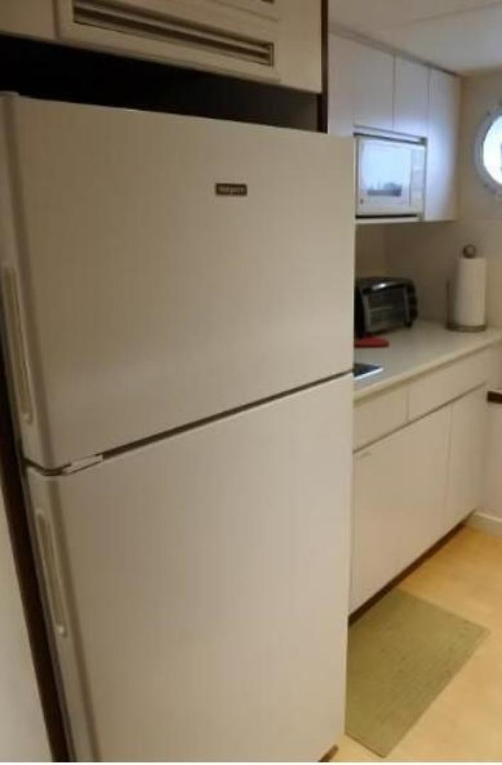 a white refrigerator in a kitchen aboard MY LADY ALASKA Yacht for Sale