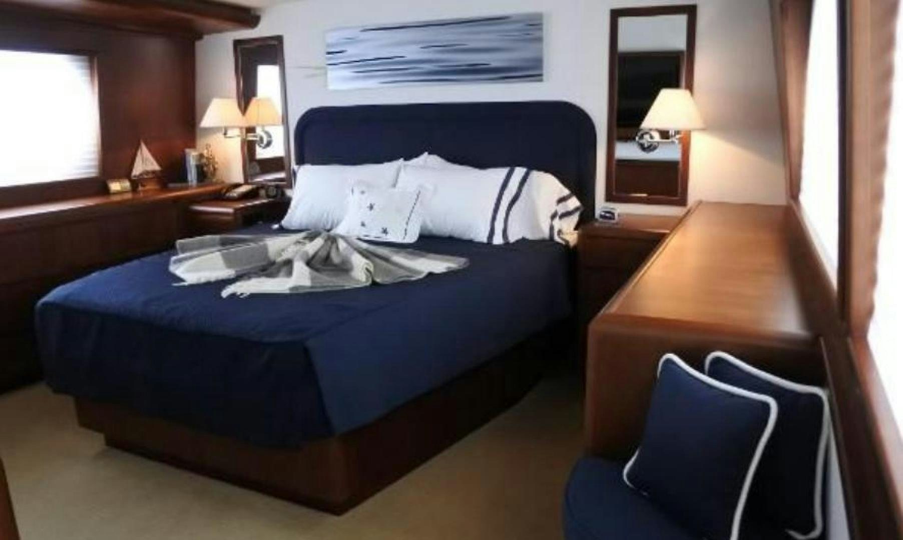 a bed with a blue comforter aboard MY LADY ALASKA Yacht for Sale
