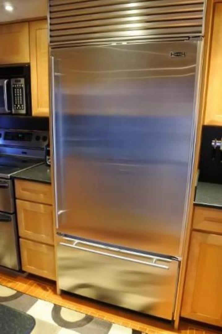 a stainless steel refrigerator in a kitchen aboard MY LADY ALASKA Yacht for Sale