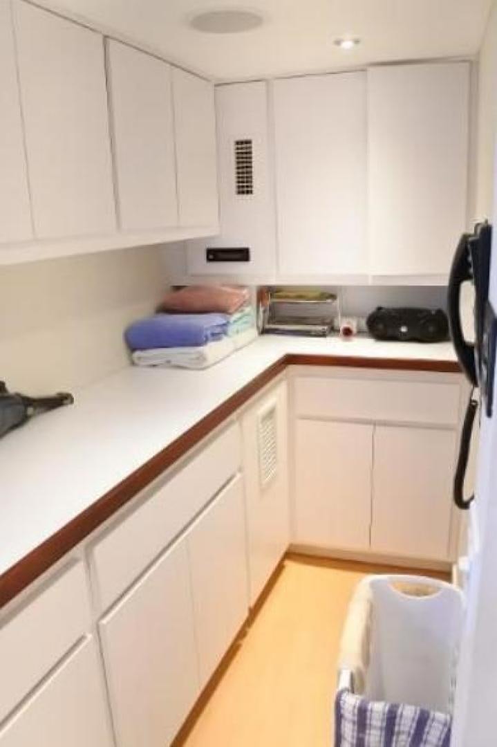 a kitchen with white cabinets aboard MY LADY ALASKA Yacht for Sale