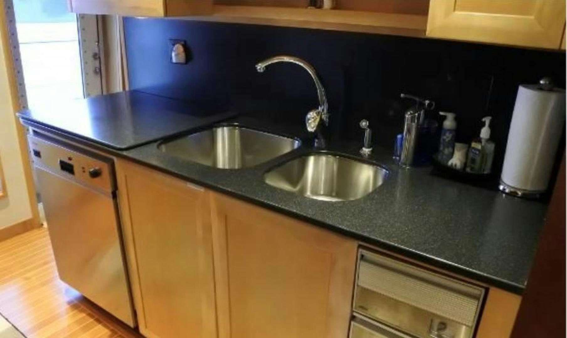 a kitchen with a sink and cabinets aboard MY LADY ALASKA Yacht for Sale