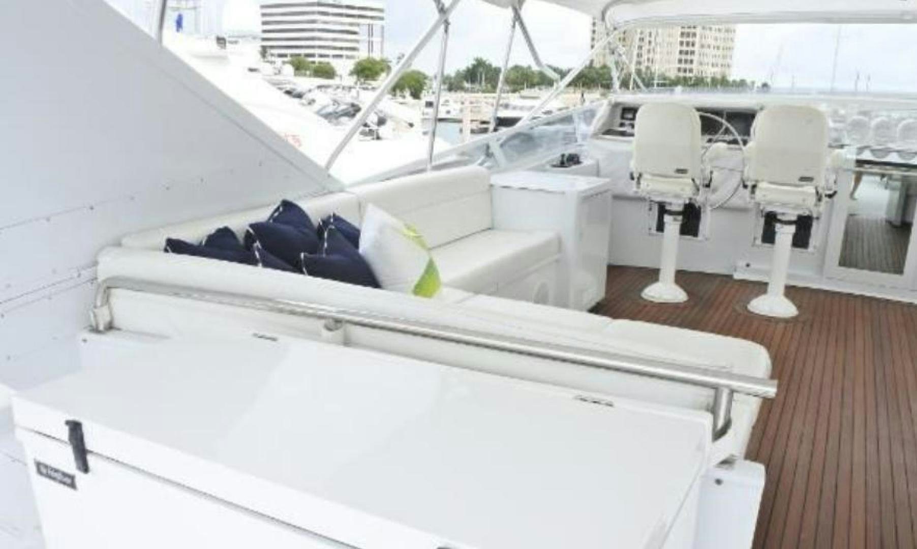 a white bed with a white bed and white chairs on a deck aboard MY LADY ALASKA Yacht for Sale
