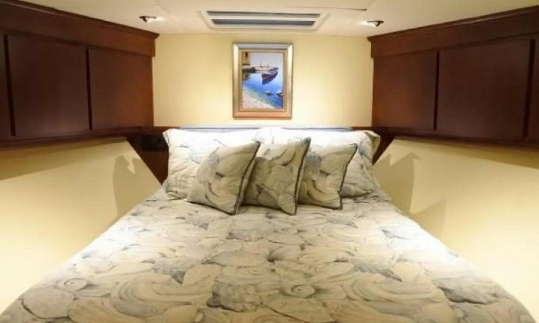 a bed with a comforter aboard MY LADY ALASKA Yacht for Sale