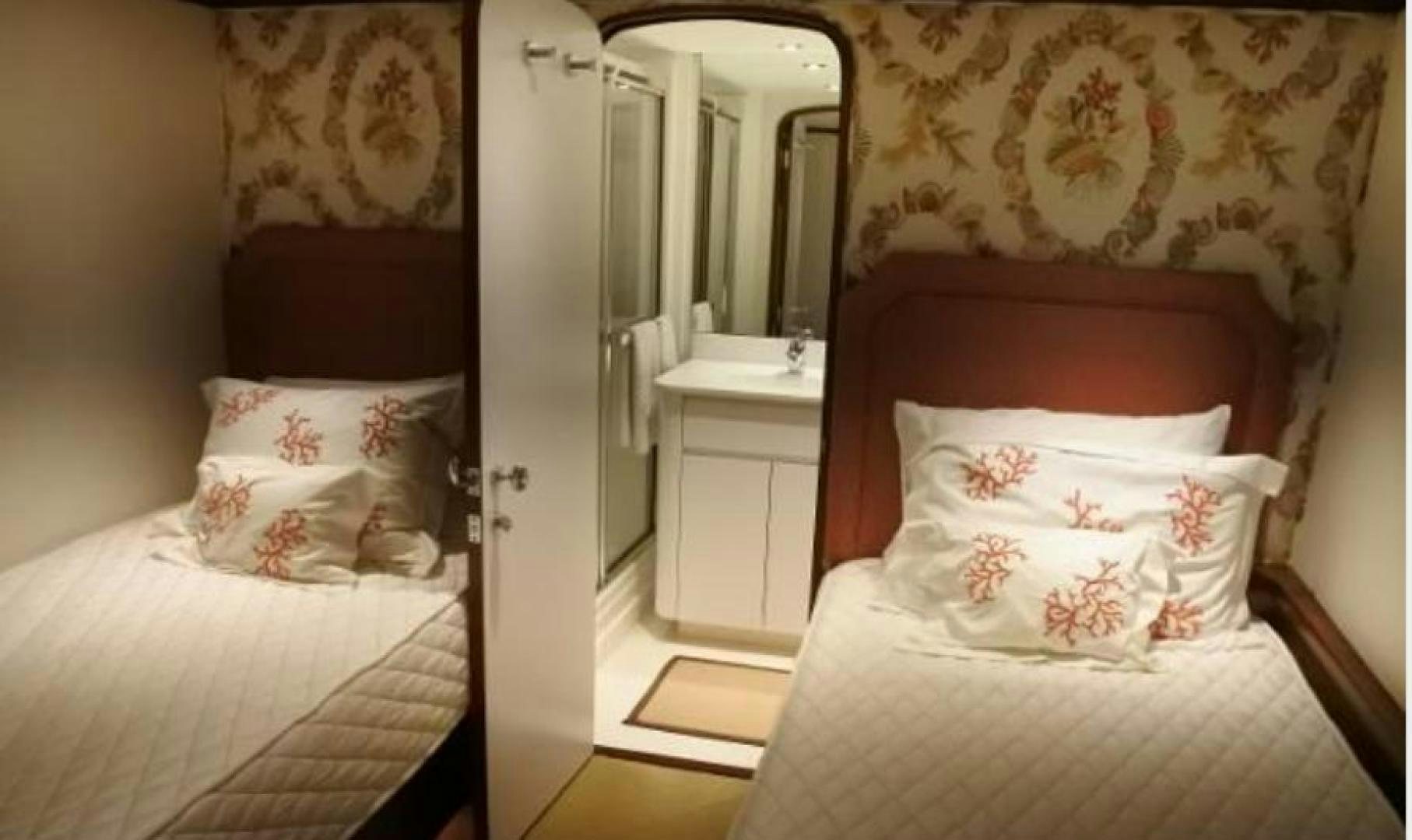 a room with a bed and a mirror aboard MY LADY ALASKA Yacht for Sale
