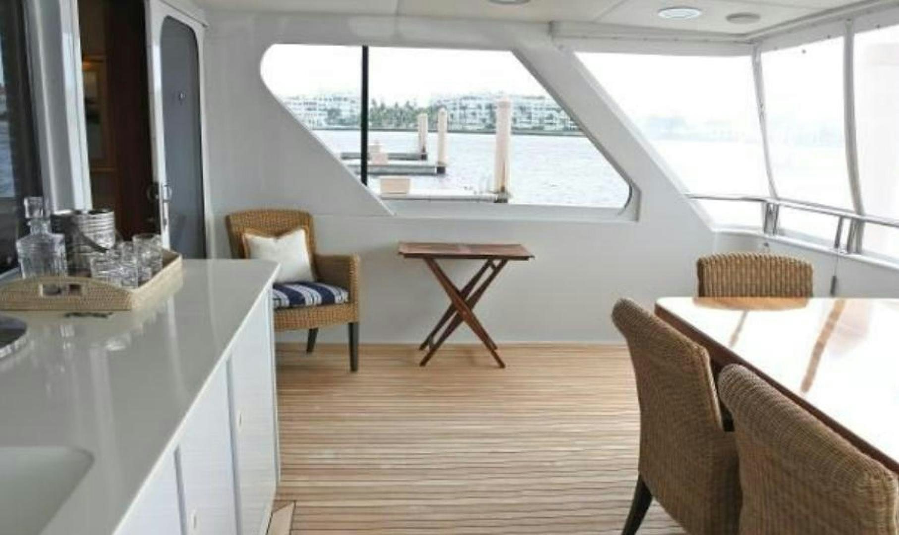 a room with a table and chairs aboard MY LADY ALASKA Yacht for Sale