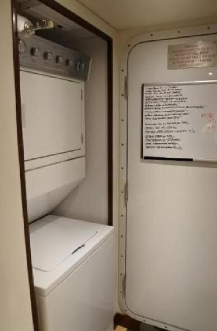 a white wall with a white door and a white board with a piece of paper on it aboard MY LADY ALASKA Yacht for Sale