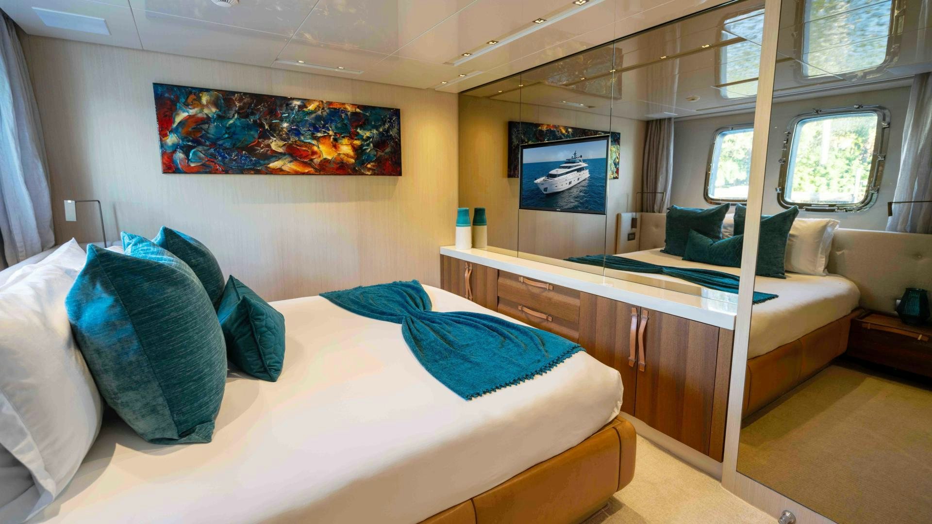 a room with a bed and desk aboard NOTORIOUS Yacht for Sale