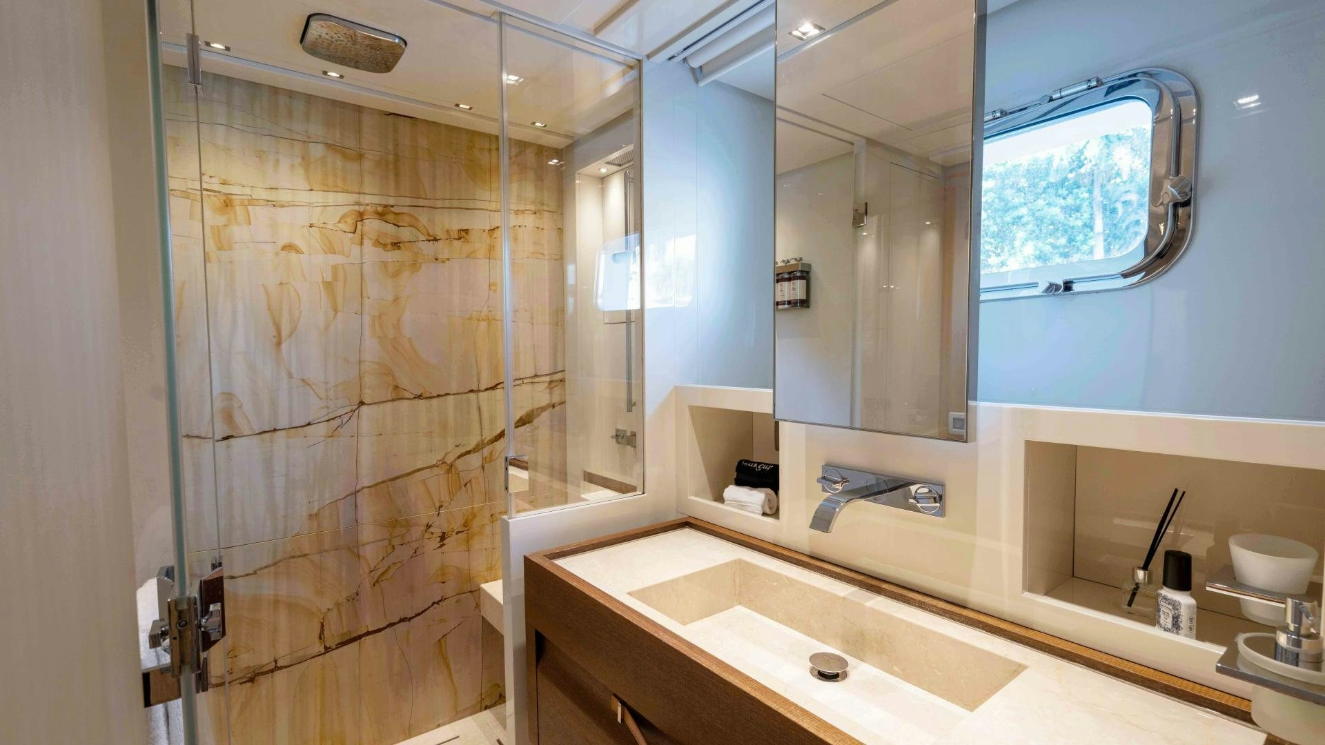 a bathroom with a glass shower aboard NOTORIOUS Yacht for Sale