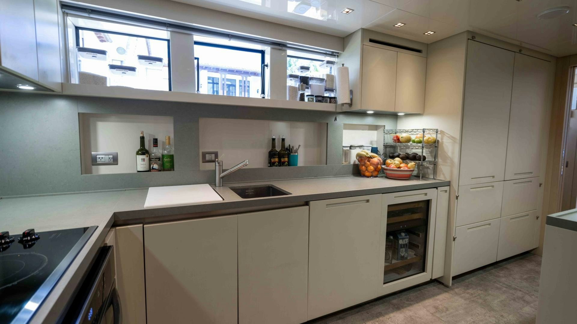 a kitchen with white cabinets aboard NOTORIOUS Yacht for Sale