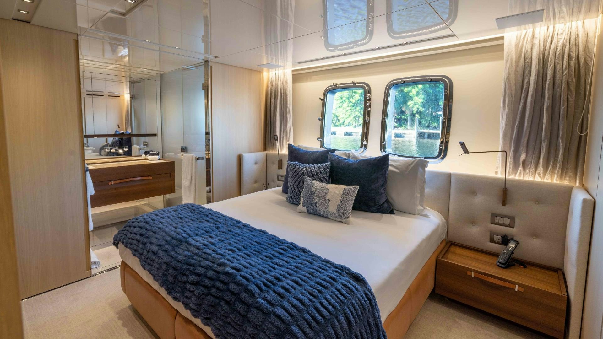 a bedroom with a bed and a desk aboard NOTORIOUS Yacht for Sale