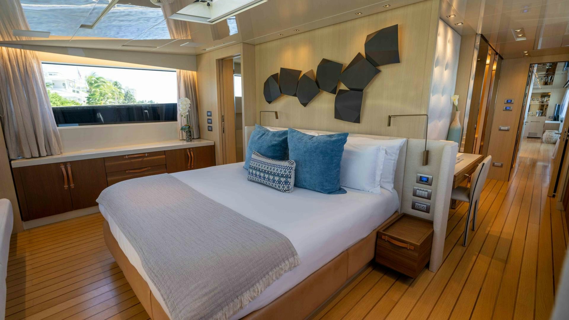 a room with a bed and a desk aboard NOTORIOUS Yacht for Sale
