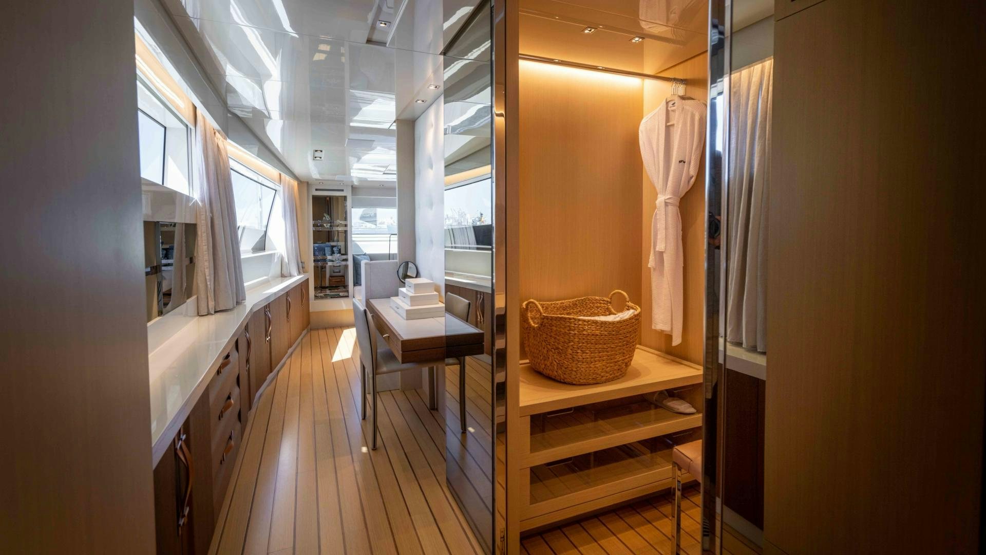 a hallway with a wood floor and a basket on the wall aboard NOTORIOUS Yacht for Sale