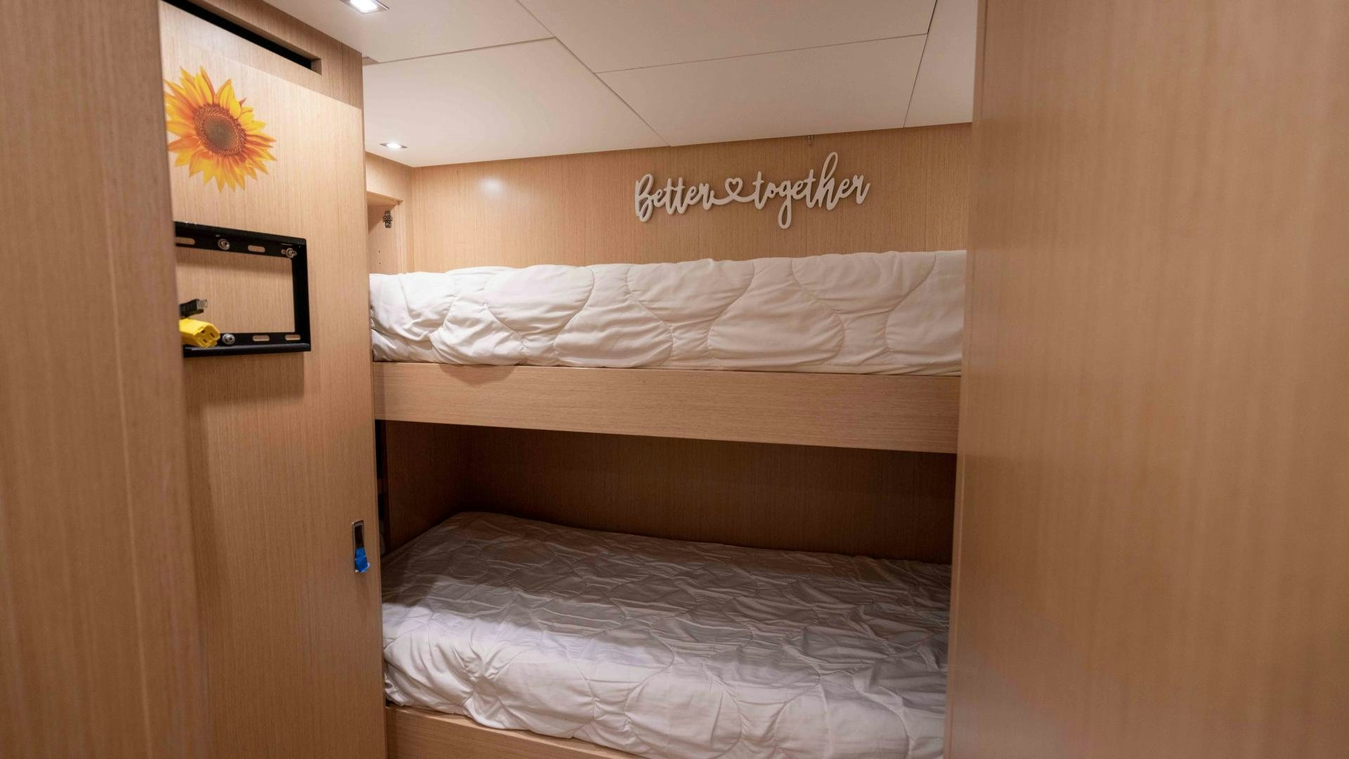 a room with a bed and a mirror aboard NOTORIOUS Yacht for Sale