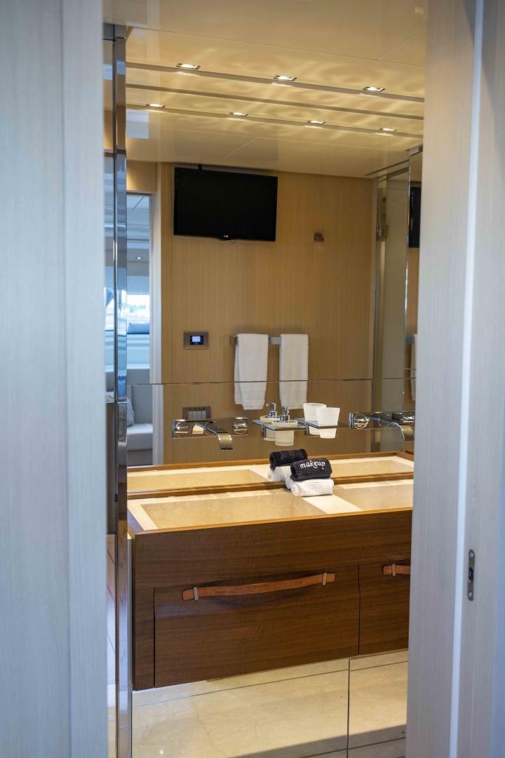 a bathroom with a sink and a tv on the wall aboard NOTORIOUS Yacht for Sale