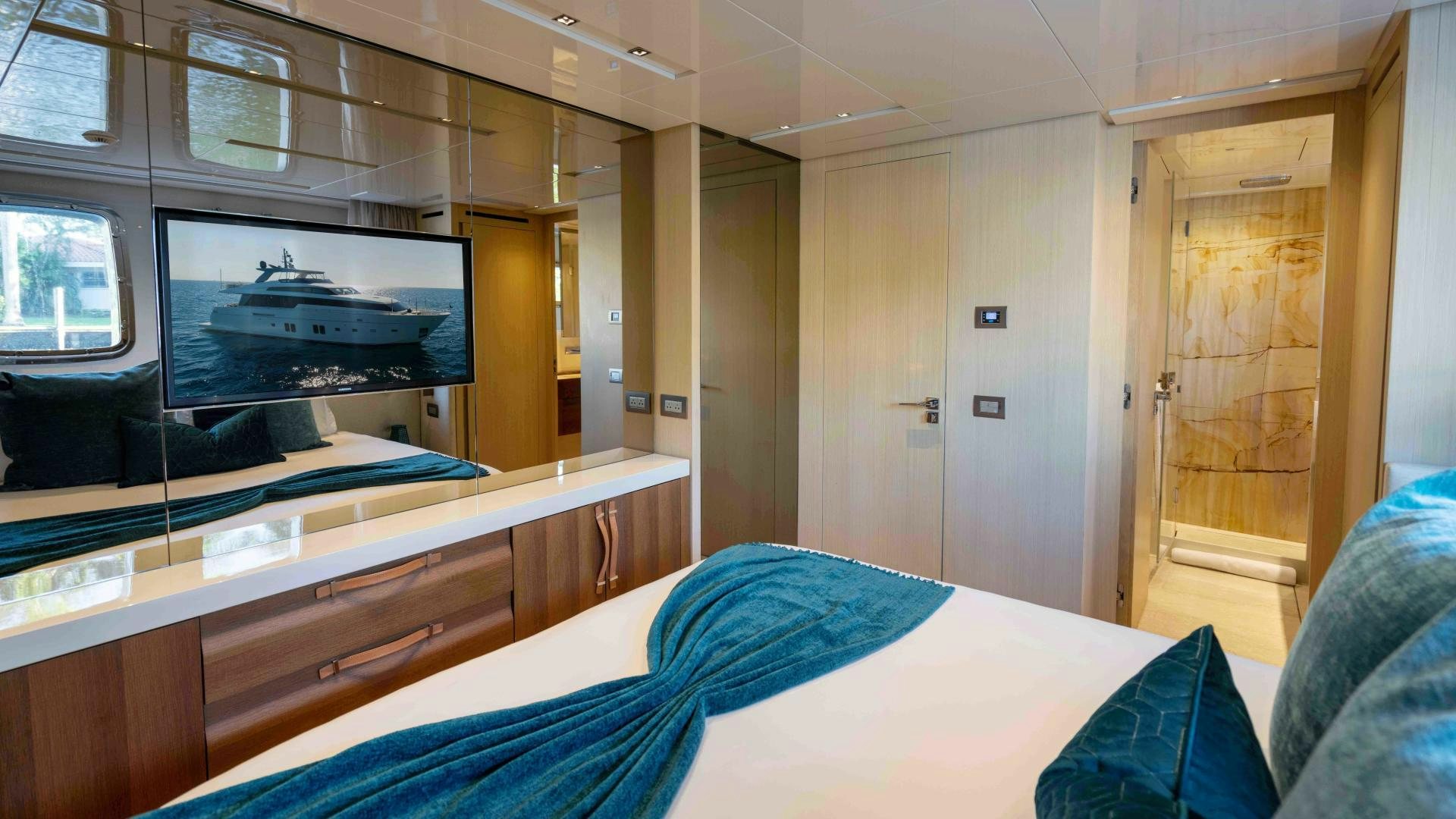 a room with a bed and a television aboard NOTORIOUS Yacht for Sale