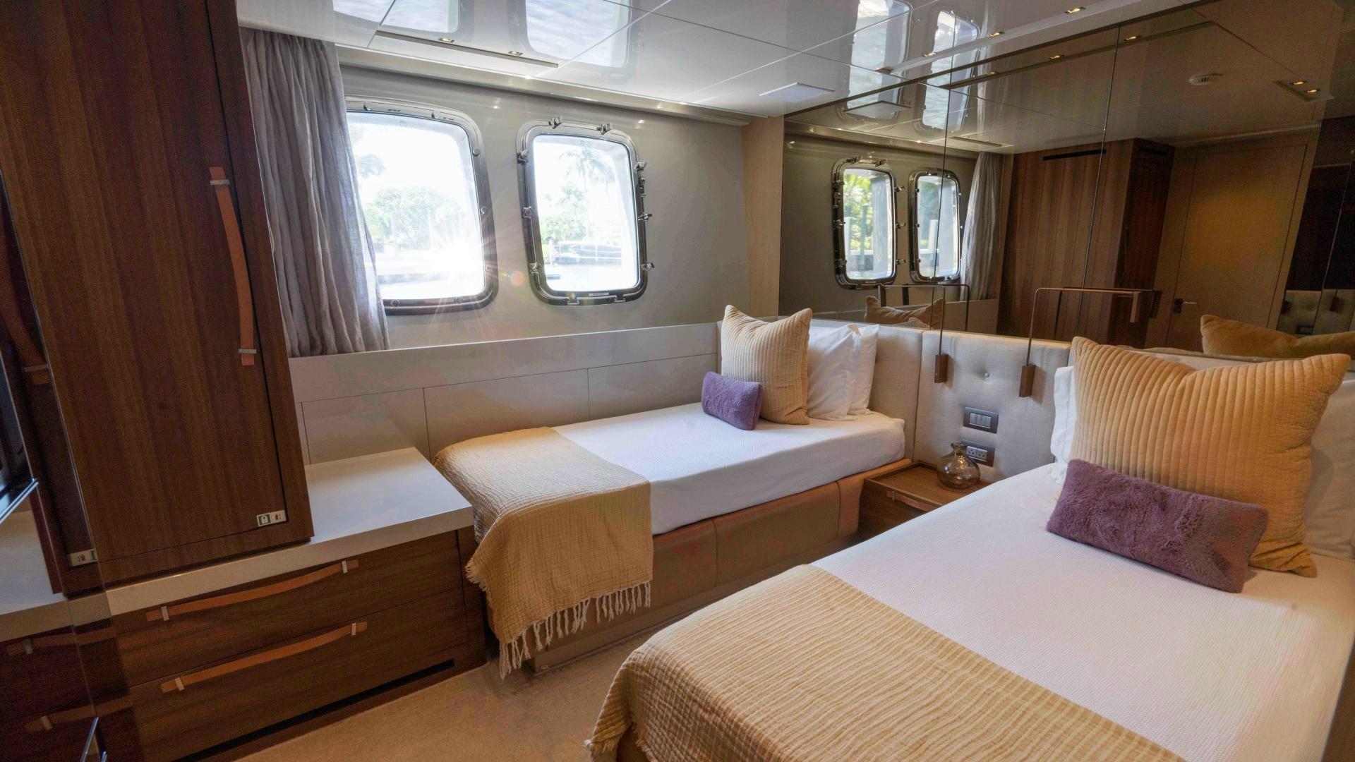 a room with beds and a window aboard NOTORIOUS Yacht for Sale