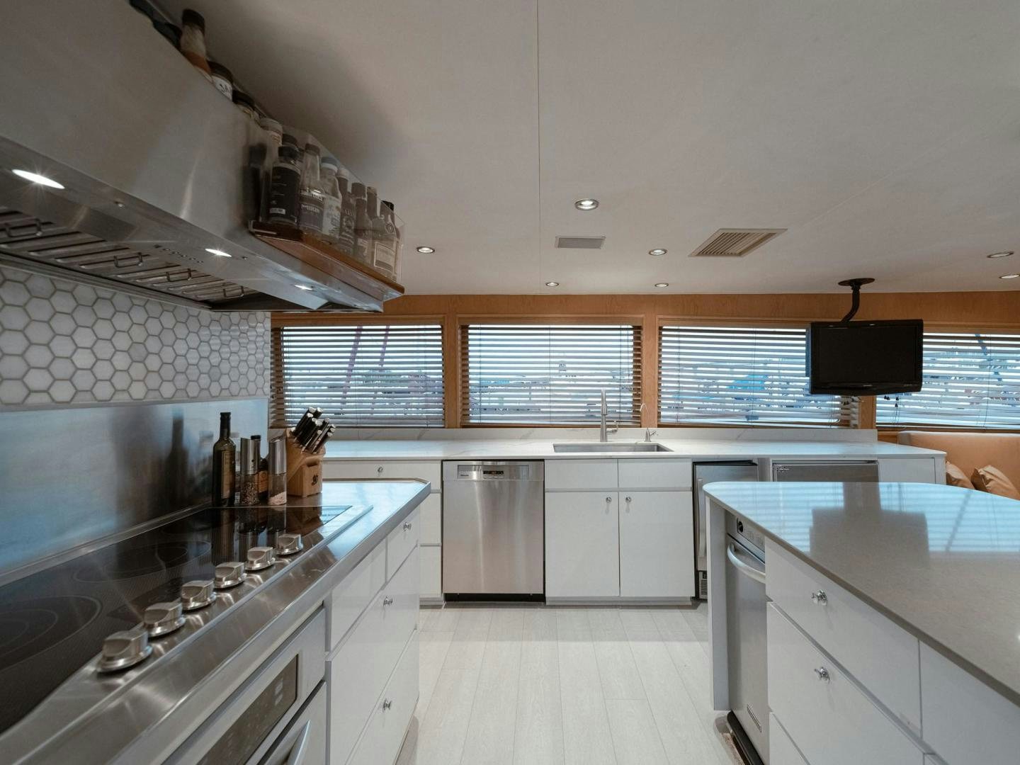 a kitchen with white cabinets aboard SKY Yacht for Sale