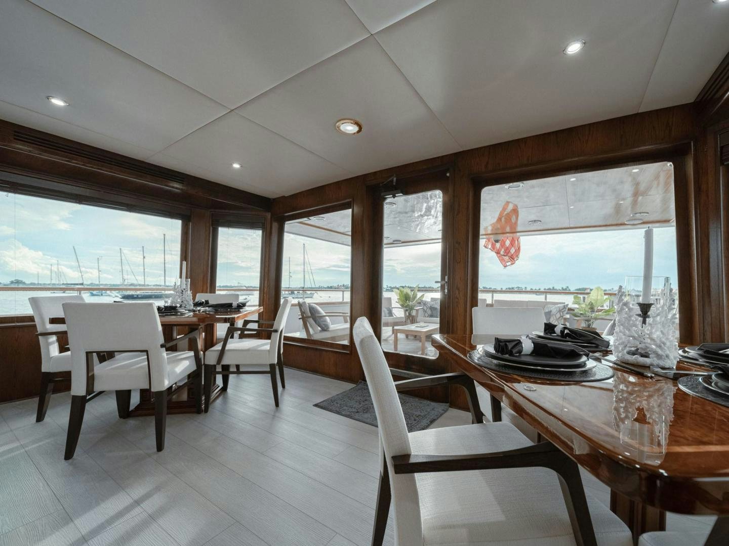 a room with a table chairs and a window aboard SKY Yacht for Sale