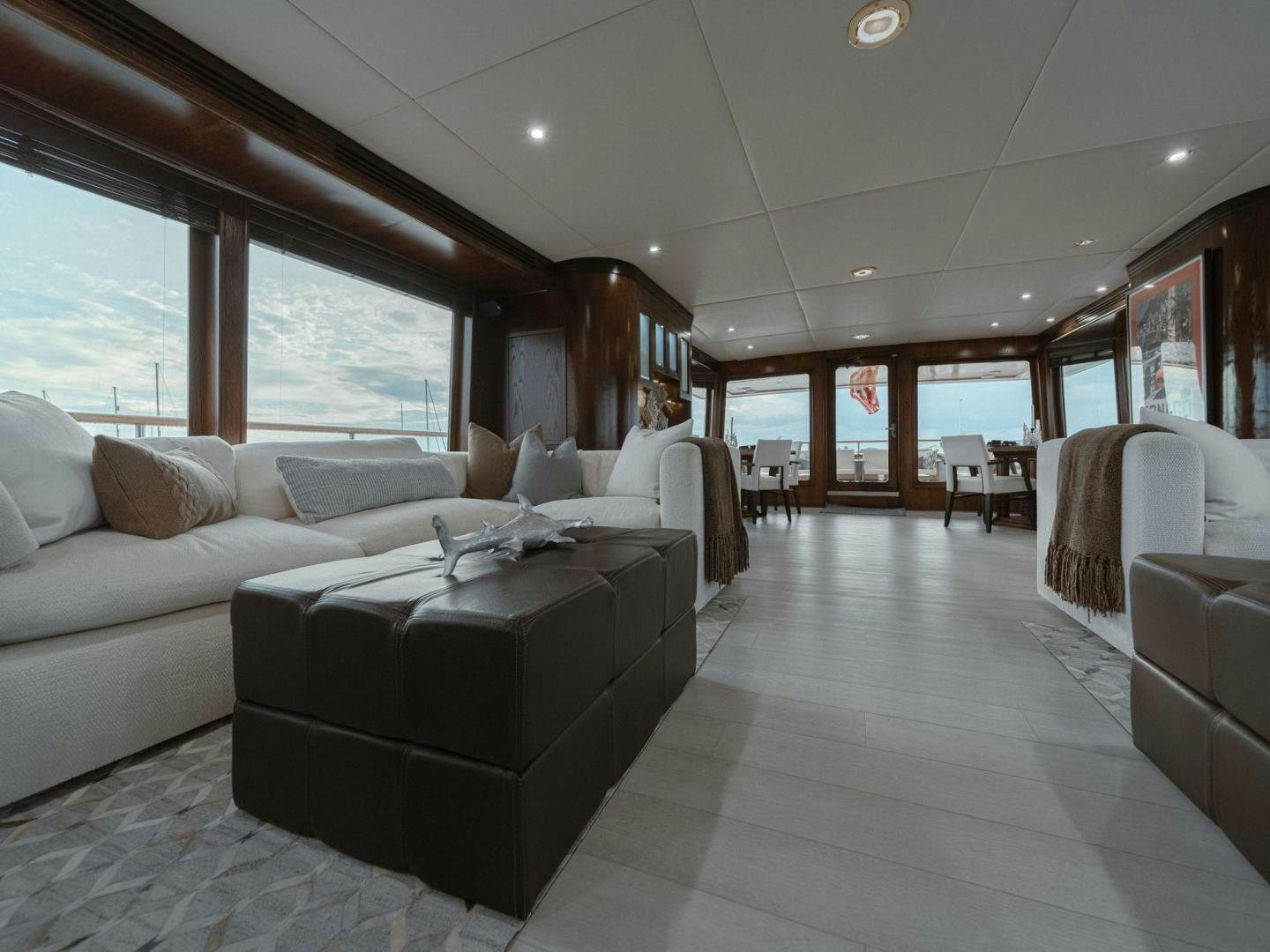 a large living room with a large window aboard SKY Yacht for Sale