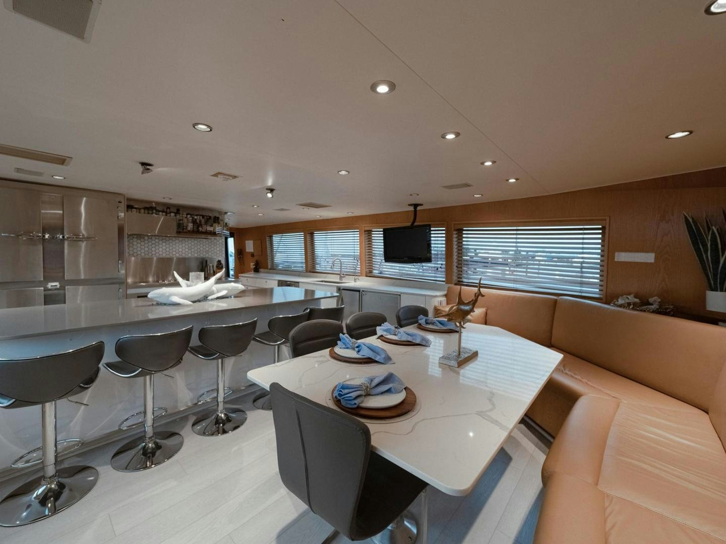 a room with a table and chairs aboard SKY Yacht for Sale