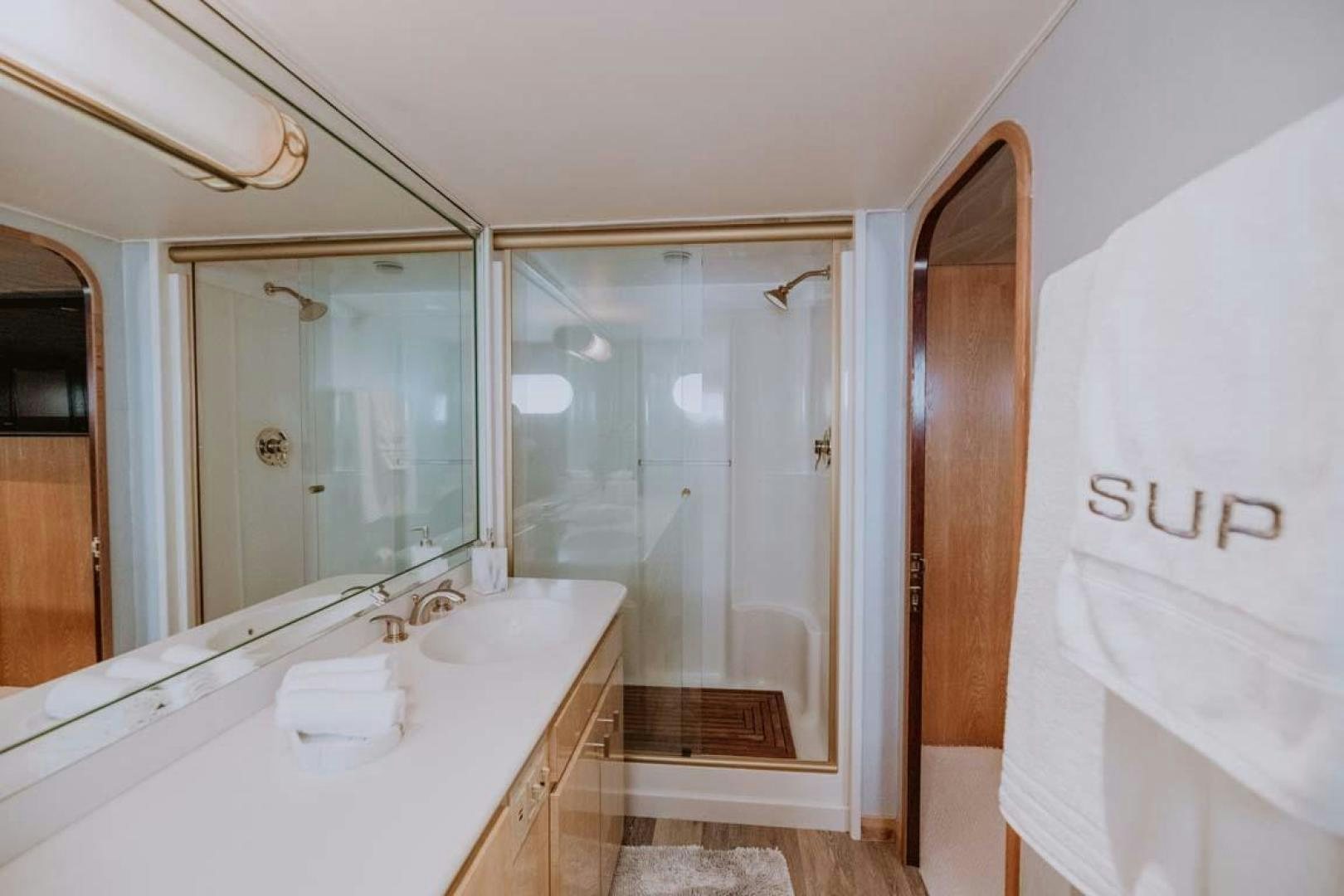 a bathroom with a bathtub and sink aboard SKY Yacht for Sale