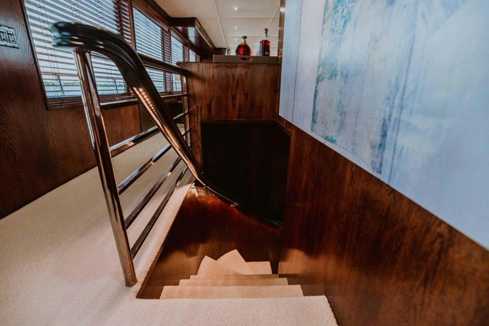 a wooden staircase in a building aboard SKY Yacht for Sale
