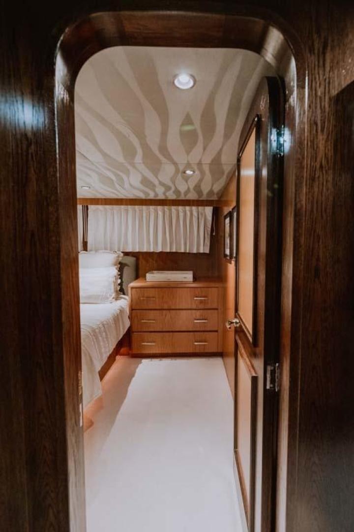 a bedroom with a bed and a mirror aboard SKY Yacht for Sale