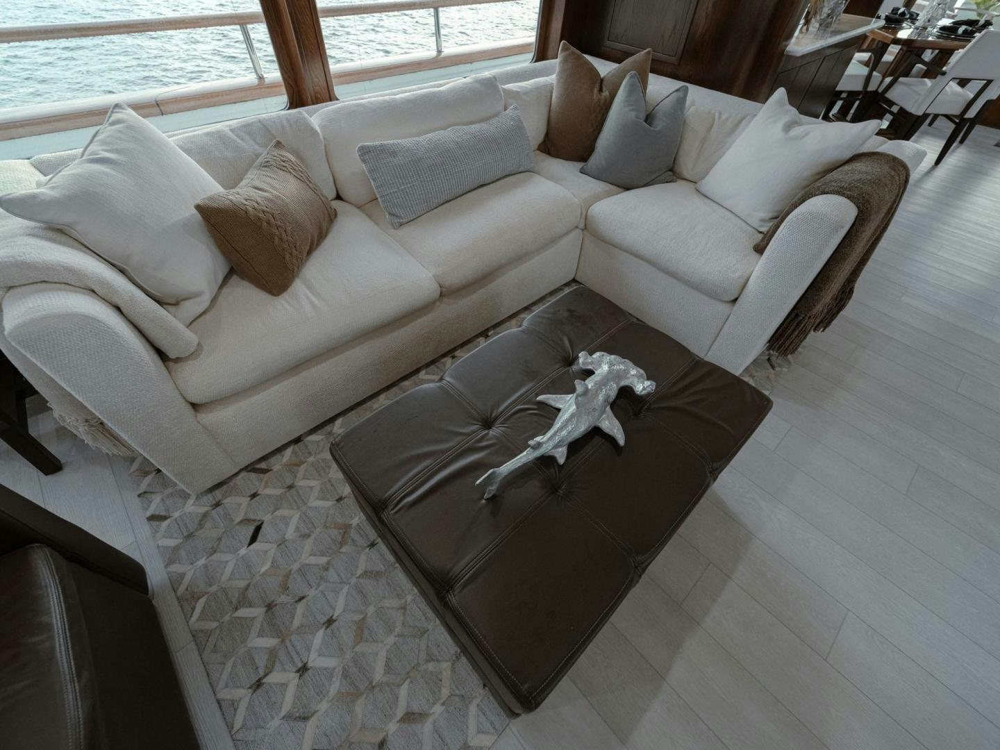 a couch with a pillow and a chair in a room aboard SKY Yacht for Sale