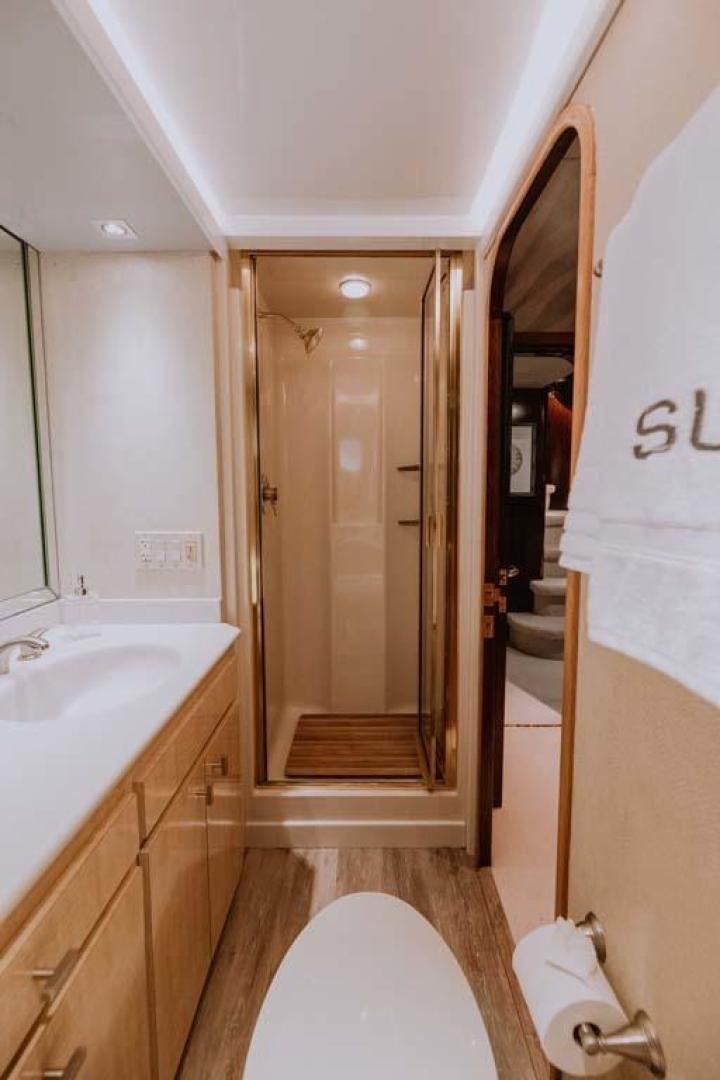 a bathroom with a glass shower aboard SKY Yacht for Sale