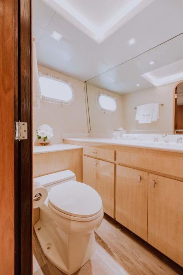 a bathroom with a toilet and a sink aboard SKY Yacht for Sale
