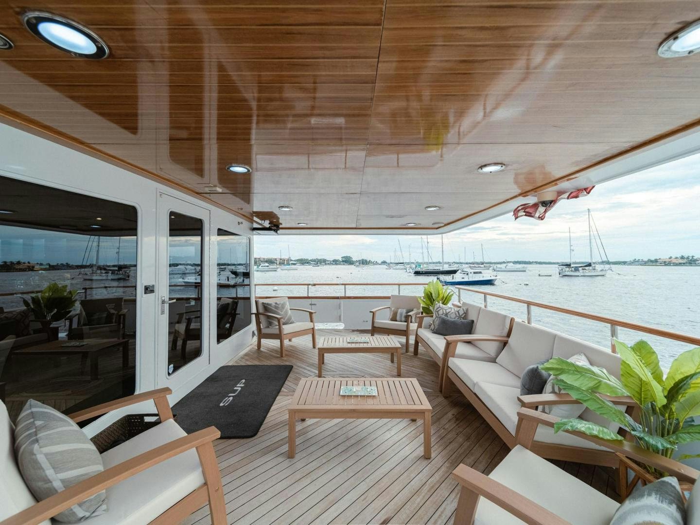 a room with a table and chairs aboard SKY Yacht for Sale