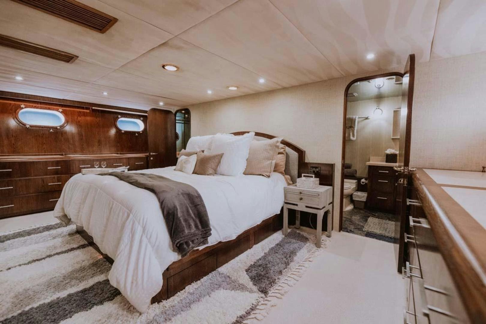 a bedroom with a large bed aboard SKY Yacht for Sale