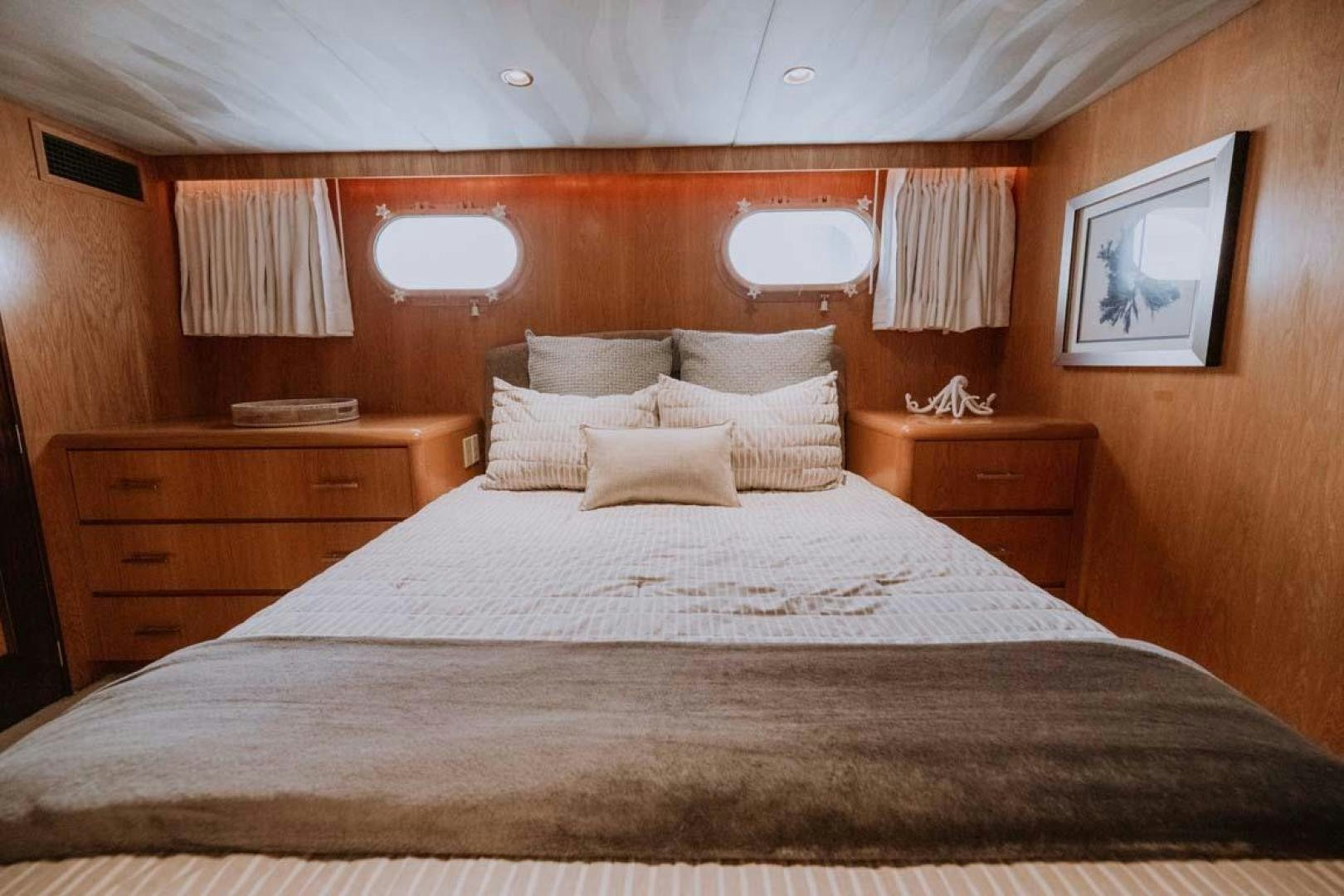 a bed with white sheets aboard SKY Yacht for Sale