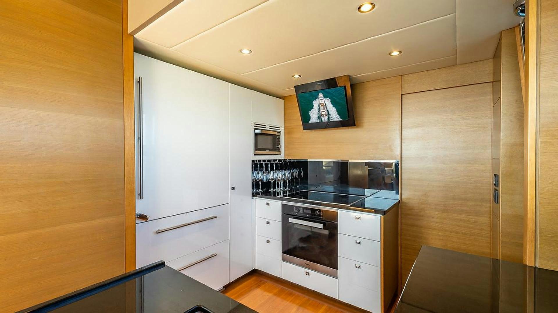 a kitchen with a tv and cabinets aboard FREEDOM Yacht for Sale