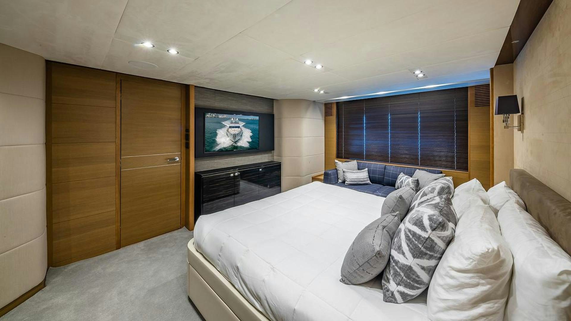 a bed with a television on the wall aboard FREEDOM Yacht for Sale