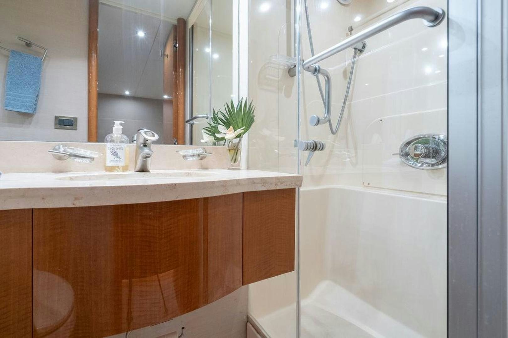 a bathroom with a shower and sink aboard CHIP Yacht for Sale