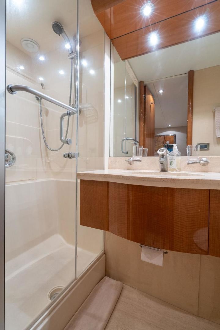 a bathroom with a shower and sink aboard CHIP Yacht for Sale