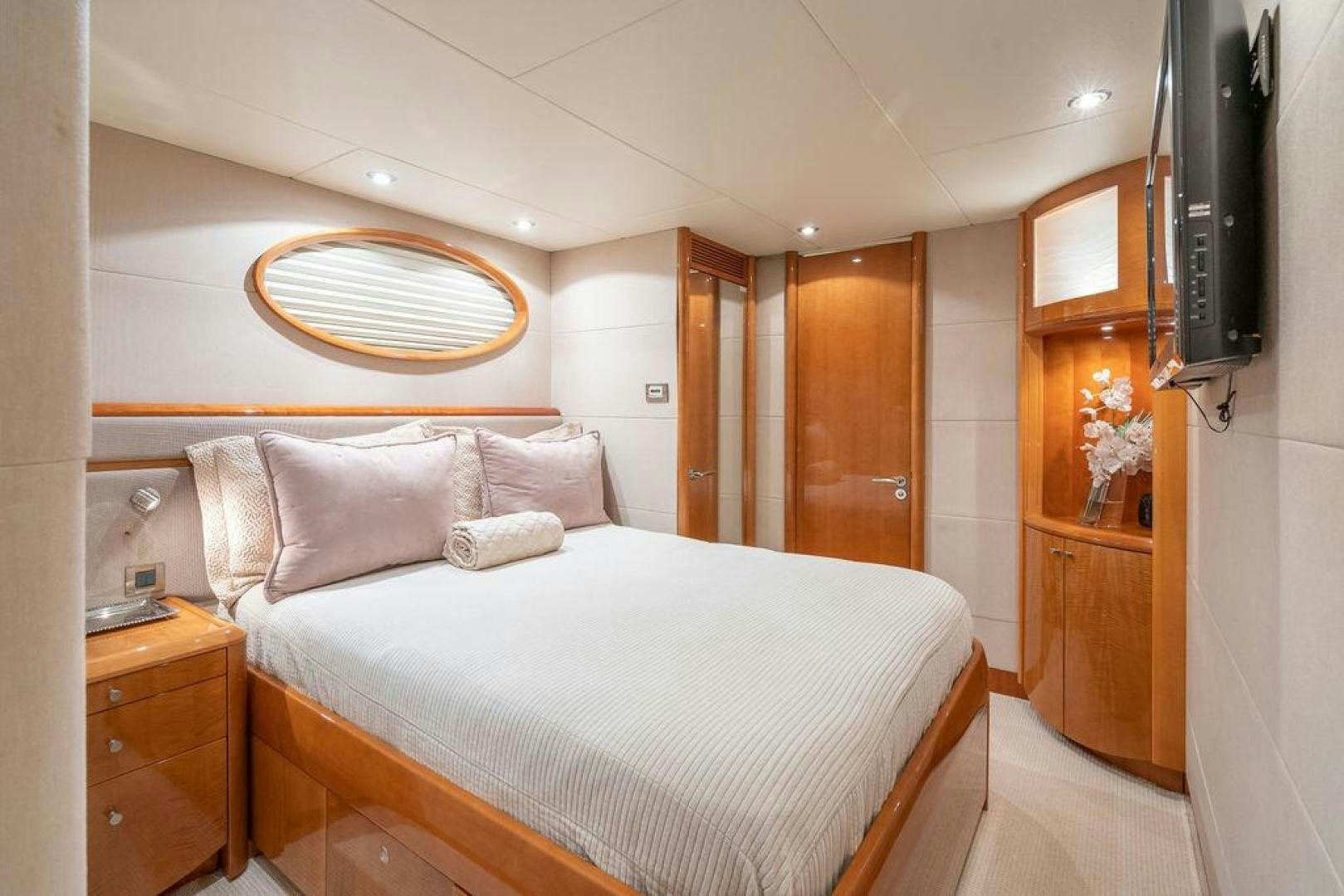 a bedroom with a bed and a dresser aboard CHIP Yacht for Sale