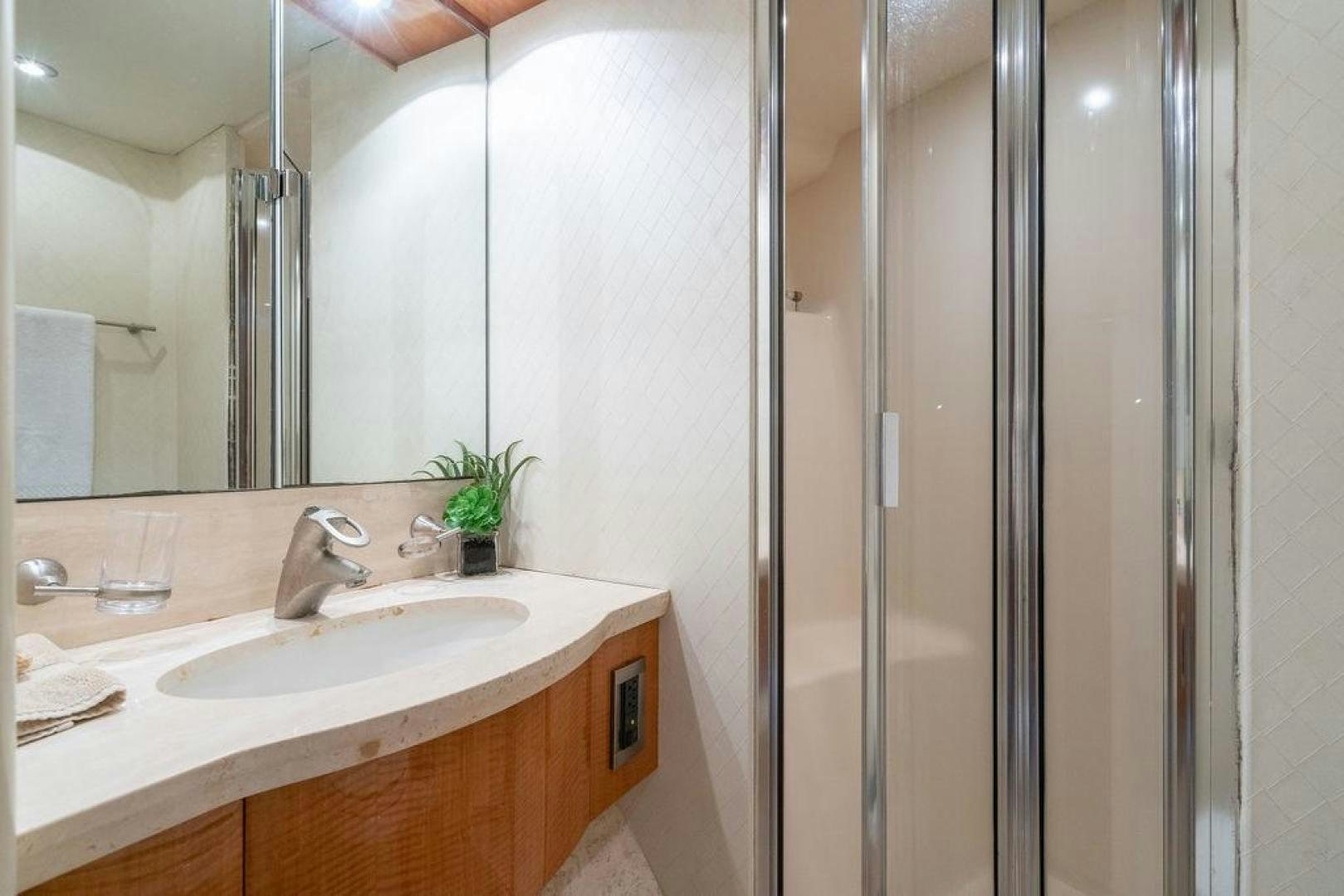 a bathroom with a sink and shower aboard CHIP Yacht for Sale