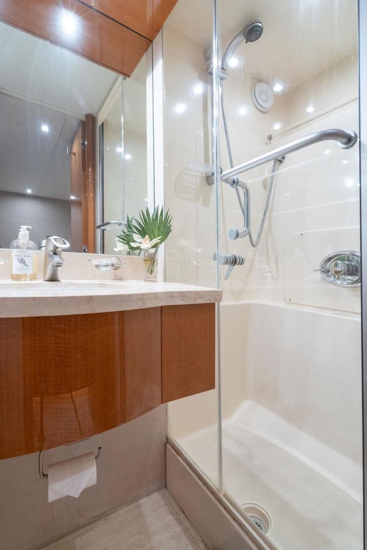 a bathroom with a shower and sink aboard CHIP Yacht for Sale