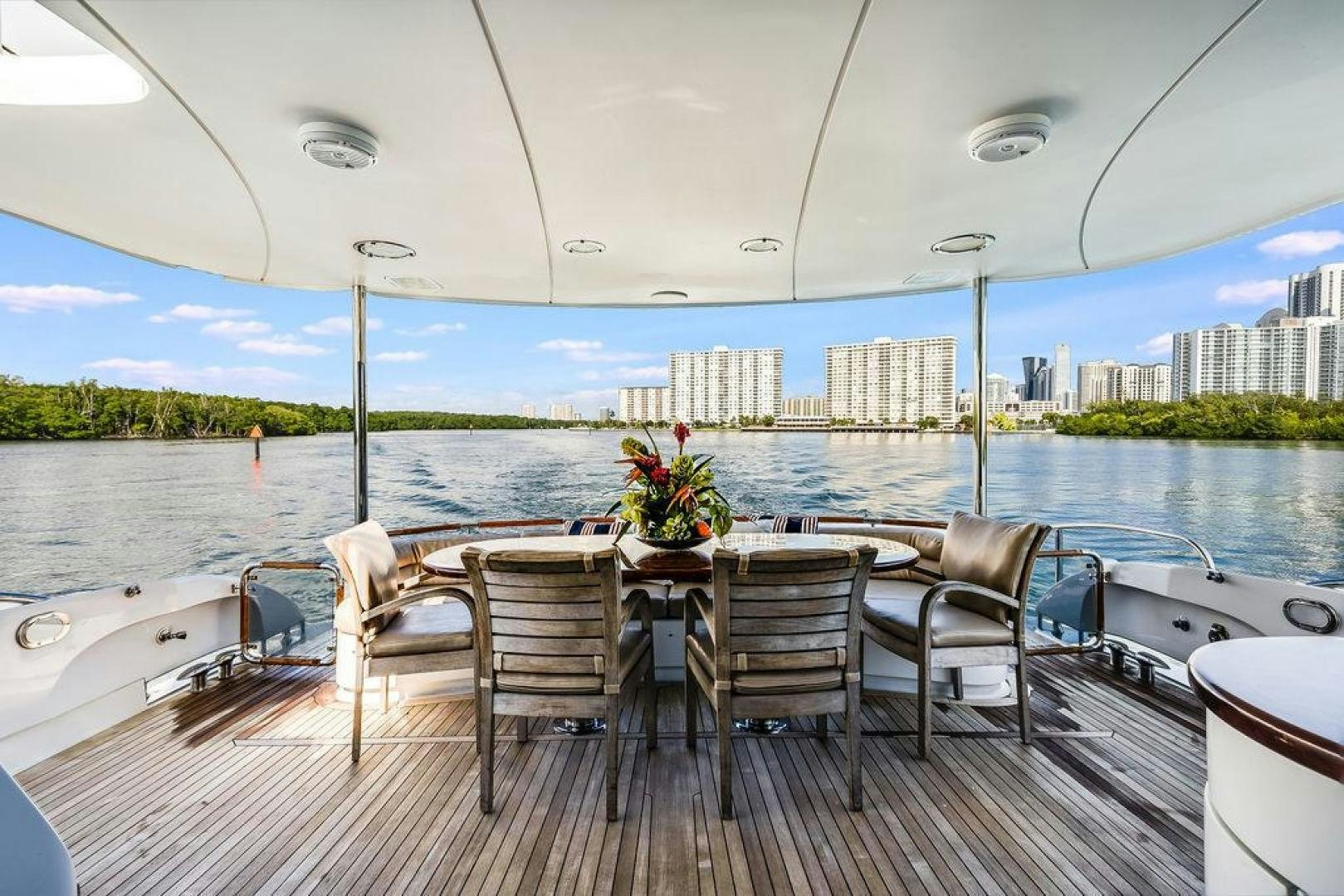 a table and chairs on a deck aboard CHIP Yacht for Sale