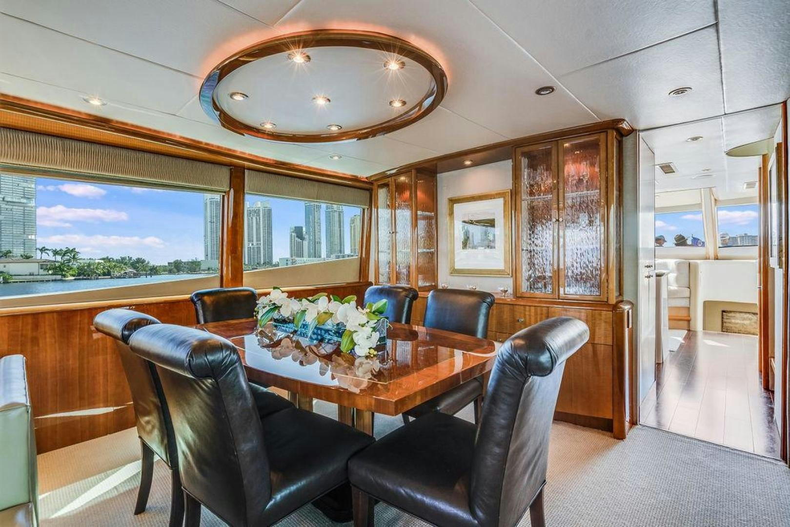 a room with a table and chairs aboard CHIP Yacht for Sale