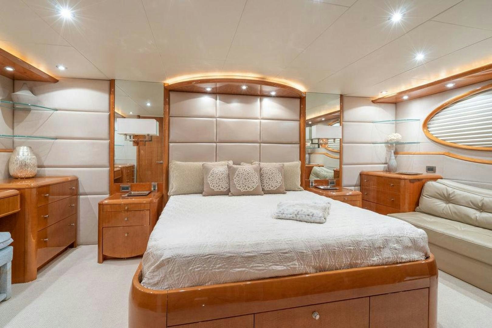 a bedroom with a bed and a mirror aboard CHIP Yacht for Sale