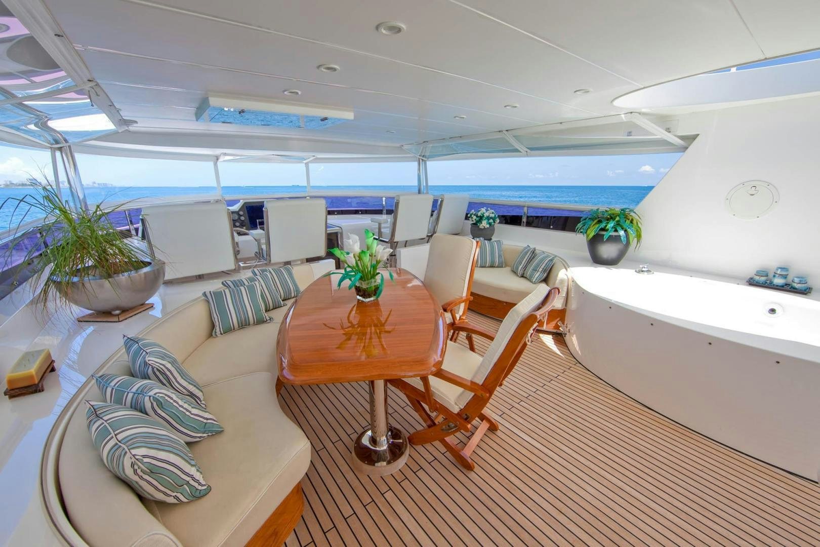 a room with a table and chairs aboard INCEPTION Yacht for Sale