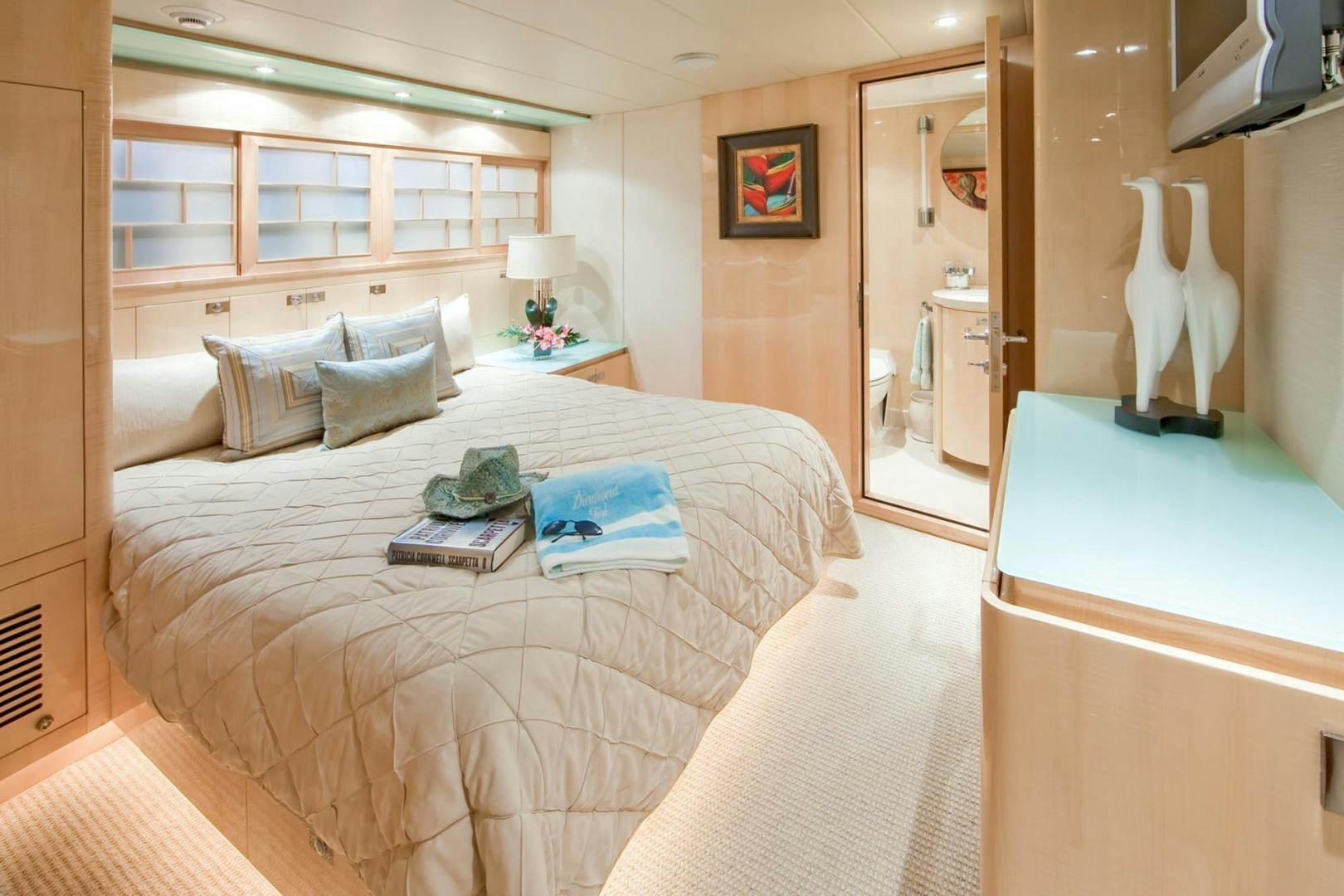 a bedroom with a bed and a desk aboard INCEPTION Yacht for Sale