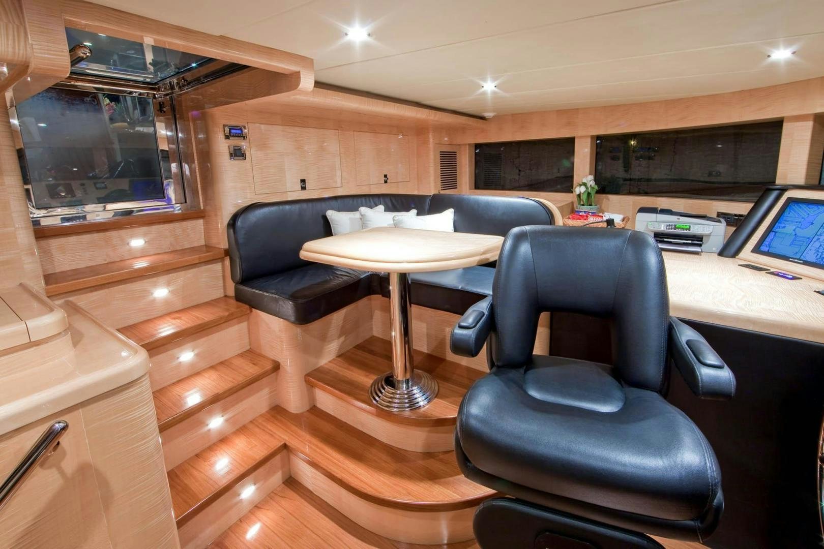 a room with a desk and chairs aboard INCEPTION Yacht for Sale