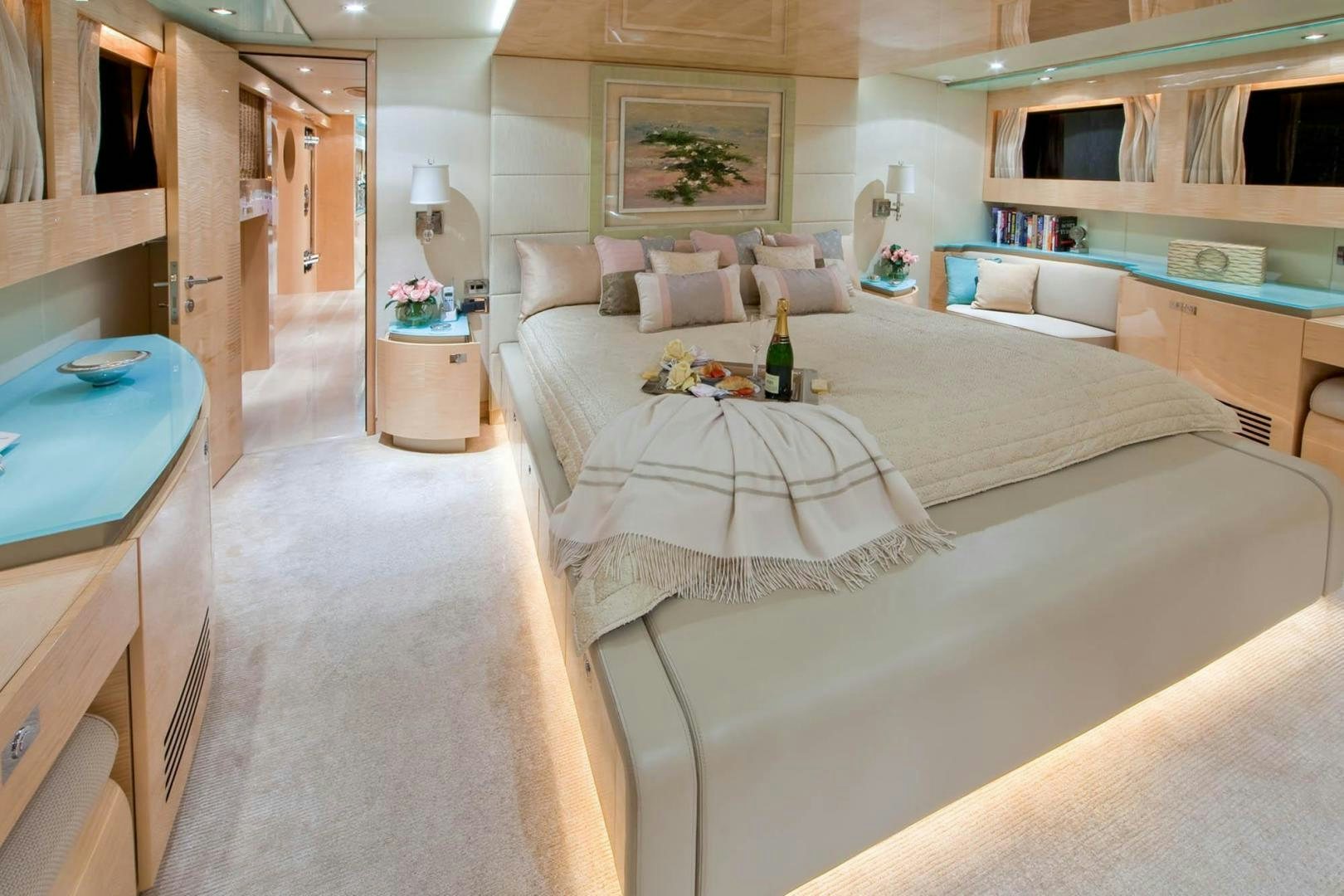 a room with a bed and a table aboard INCEPTION Yacht for Sale