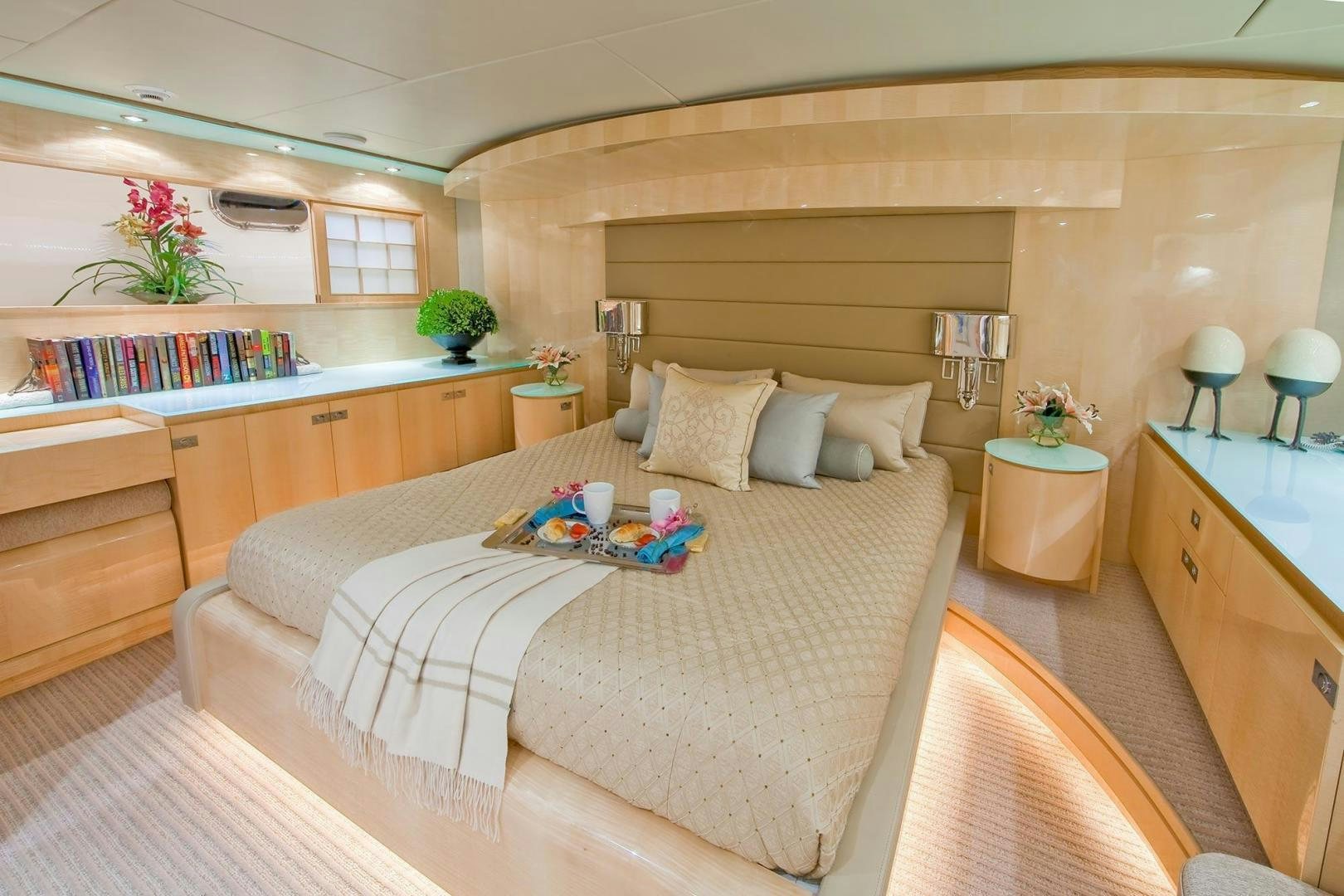 a bedroom with a bed and a desk aboard INCEPTION Yacht for Sale