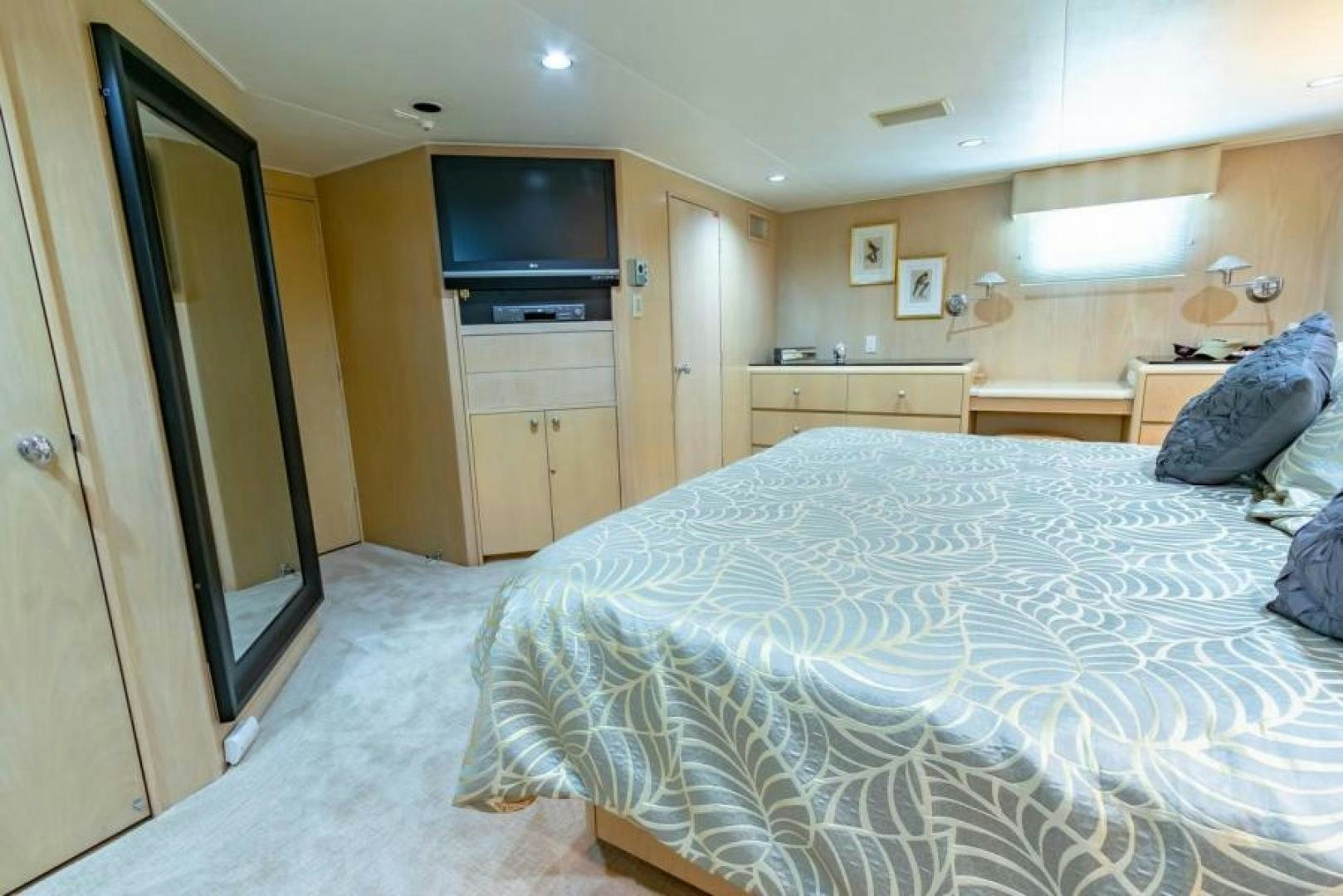 a bedroom with a bed and a television aboard K Yacht for Sale