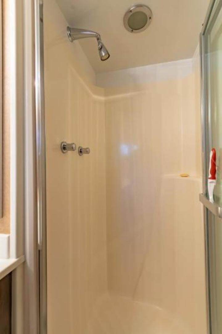 a shower with a white door aboard K Yacht for Sale